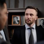 Group of men in suits having a serious business discussion in a professional setting.